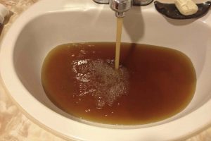 Brown water pouring from sink
