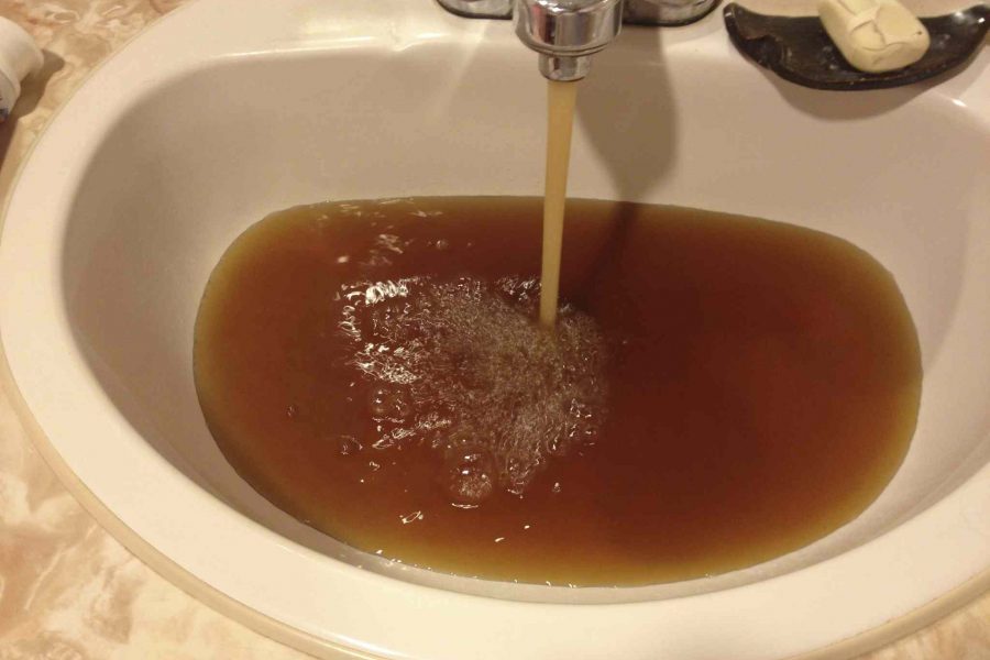 Brown water pouring from sink