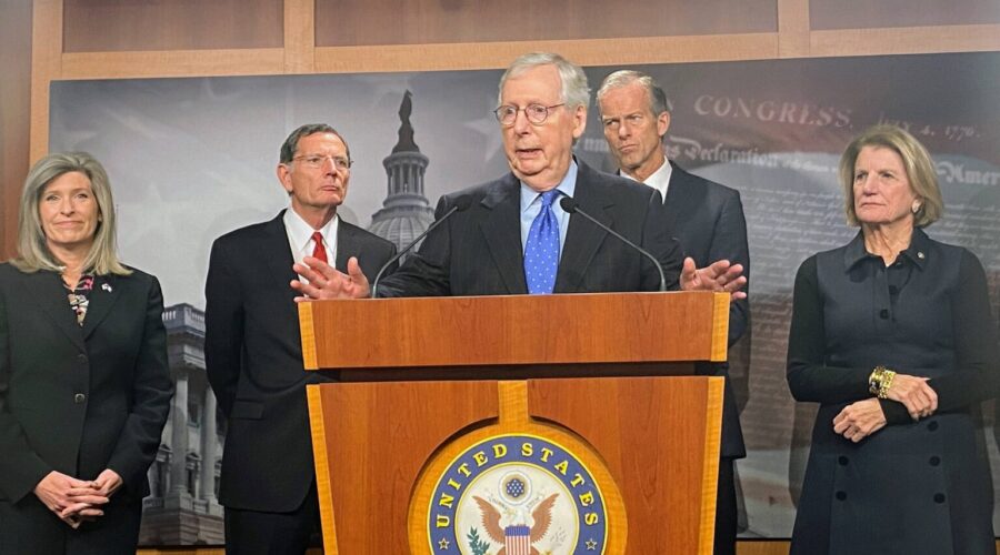 Sen. Mitch McConnell at a lectern, looking bug-eyed at something